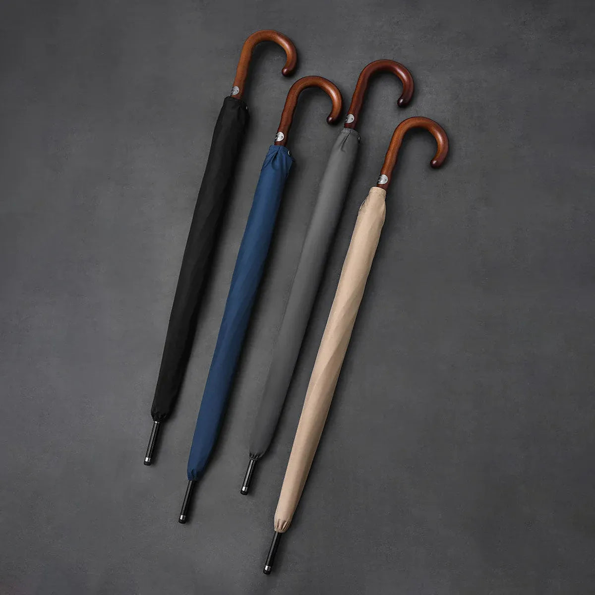 All four color options (black, blue, grey, khaki) of the Gentleman's walking umbrella lined up closed.