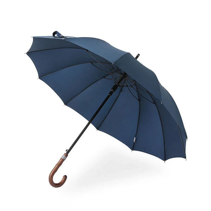 The Gentleman's walking umbrella with a handmade wooden handle, shown open in sophisticated navy blue.