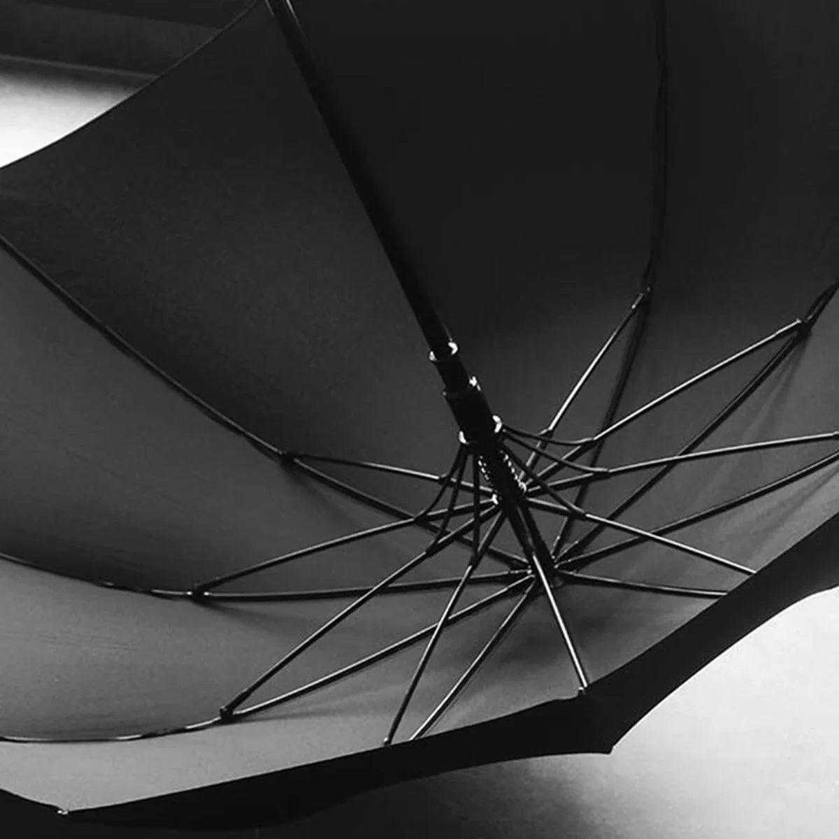 Frame detail of the gents black umbrella, featuring a durable fiberglass structure.