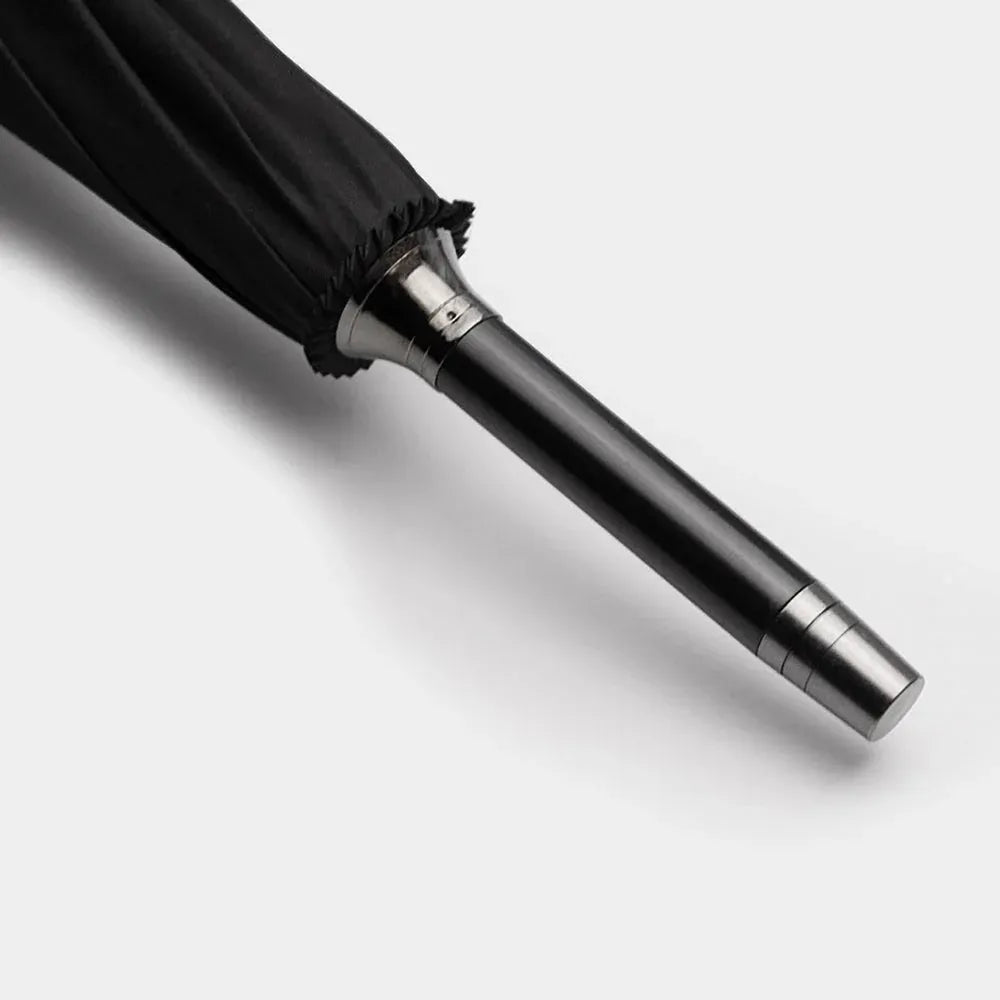 Close-up detail of the metal tip (ferrule) at the bottom end of the closed Gents Black Umbrella.