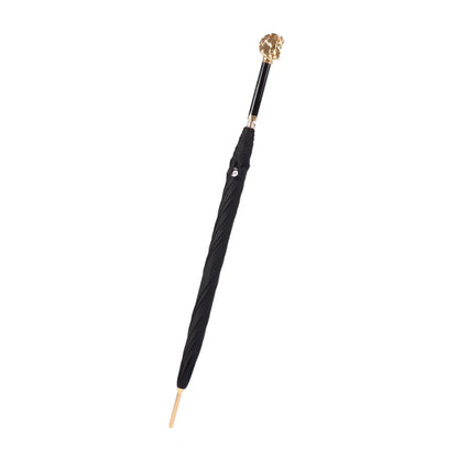 The Gold Horse Handle umbrella shown closed, highlighting the premium ebony wood grip and gold accents.