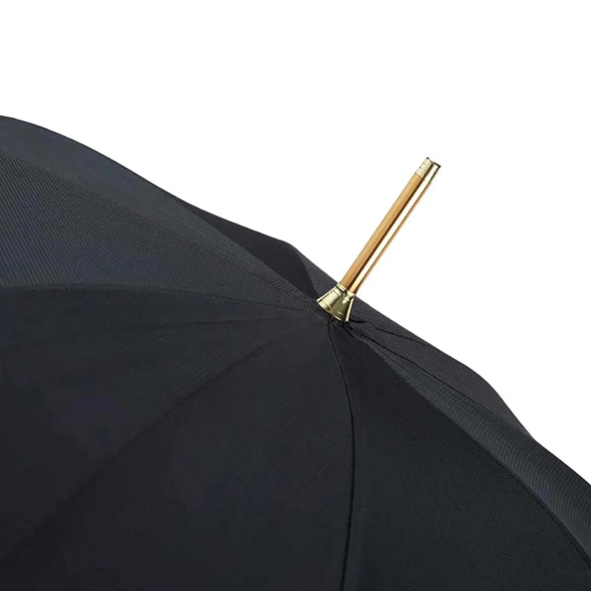 Close-up of the top of the open black canopy, showing the golden tip (ferrule).