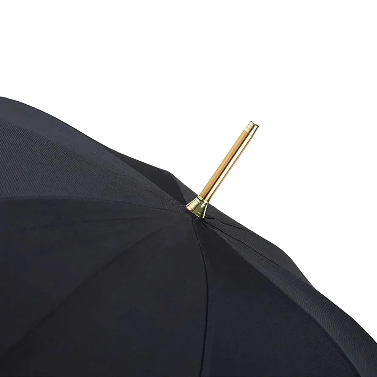 Close-up of the top of the open black canopy, showing the golden tip (ferrule).