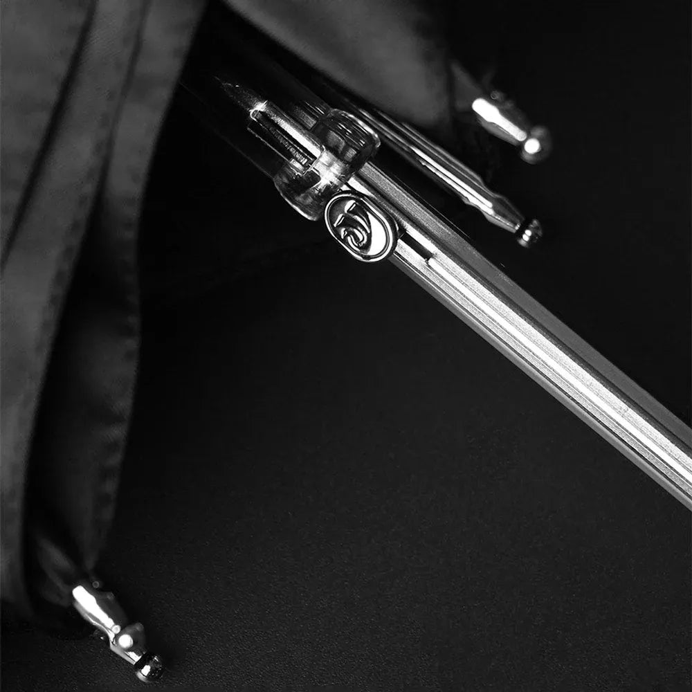 Close-up monochrome shot of the semi-automatic opening mechanism on the umbrella shaft.