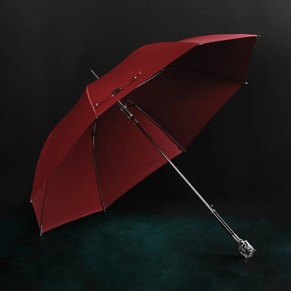 Profile view of the open red canopy on the elegant silver horse head handle umbrella.