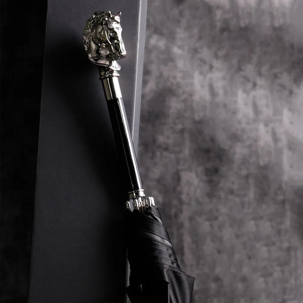 The elegant stick umbrella with a silver horse head handle, shown closed in black.