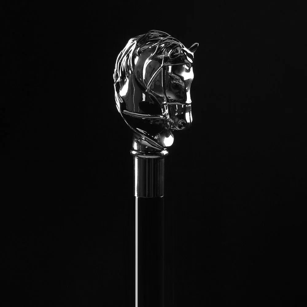 Detailed close-up of the intricately sculpted silver-plated horse head handle against a black background.