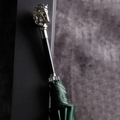 The elegant stick umbrella with a silver horse head handle, shown closed in green.