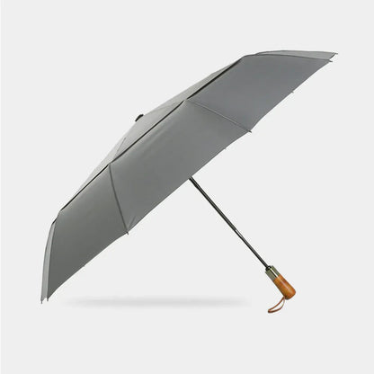 Full profile view of the open large automatic folding umbrella in grey with wood handle.