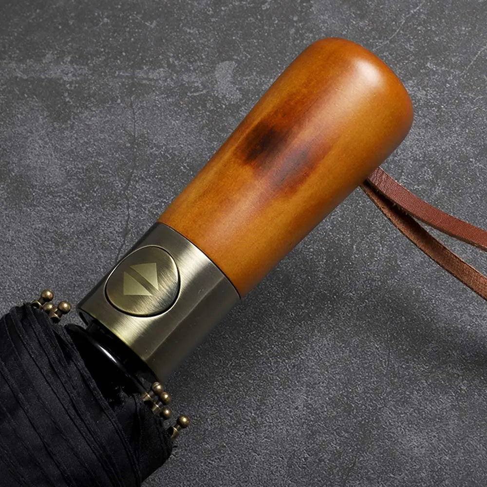 Close-up of the elegant wood handle showing the automatic open/close button and leather strap.
