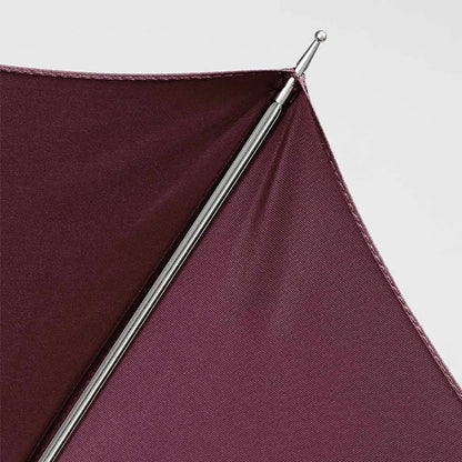 Detail shot of the metal tip on the edge of the burgundy canopy.