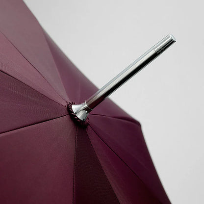 Close-up detail of the silver top ferrule on the open burgundy canopy.