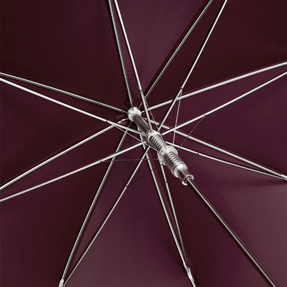 View from underneath the open burgundy canopy showing the durable frame structure.