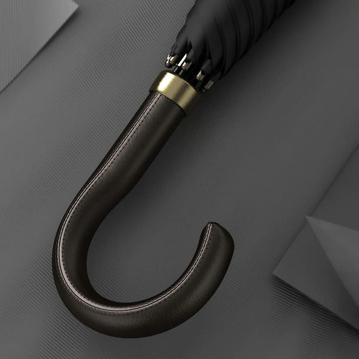 Detailed close-up of the stitched black leather crook handle with gold accents.