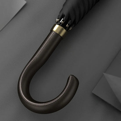 Detailed close-up of the stitched black leather crook handle with gold accents.
