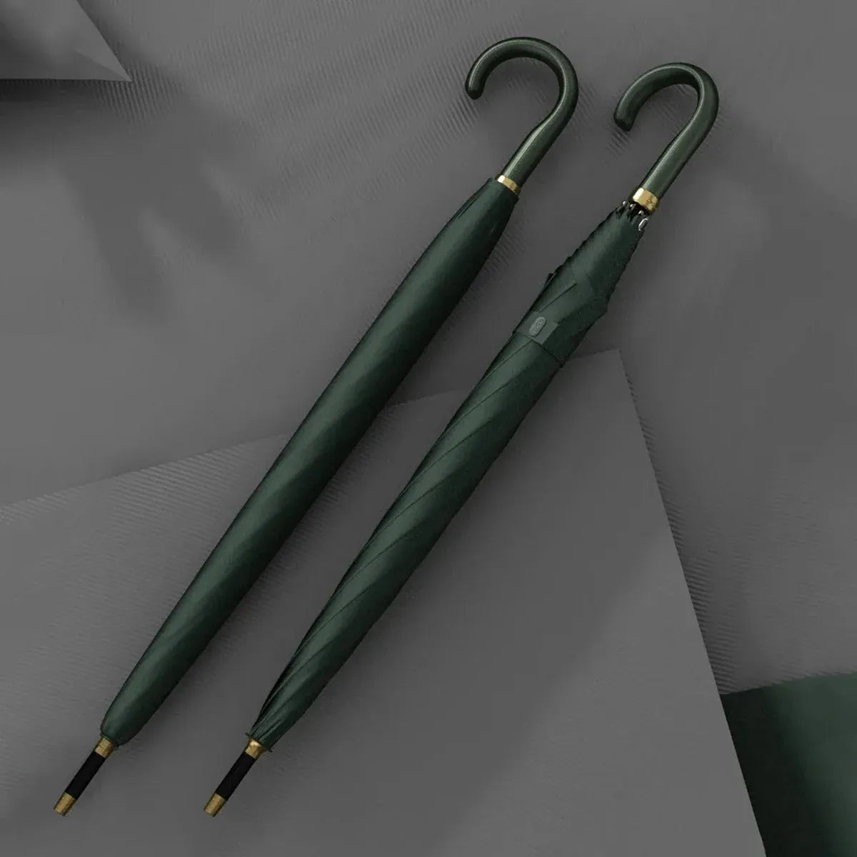 Two closed green luxury leather handle umbrellas displayed together.