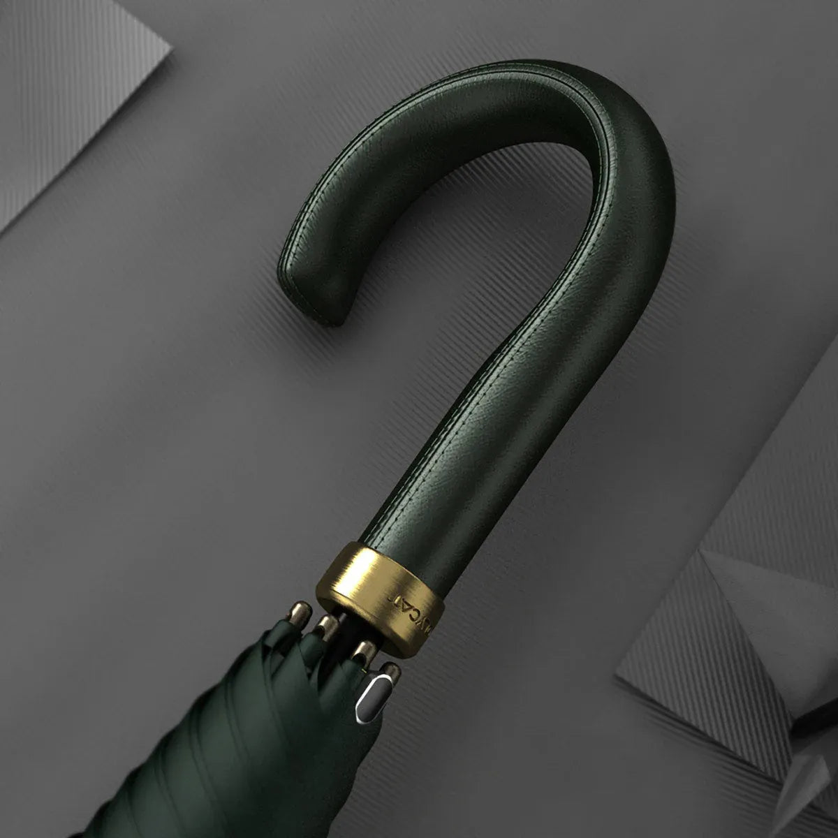 Detailed close-up of the stitched green leather crook handle with gold accents.