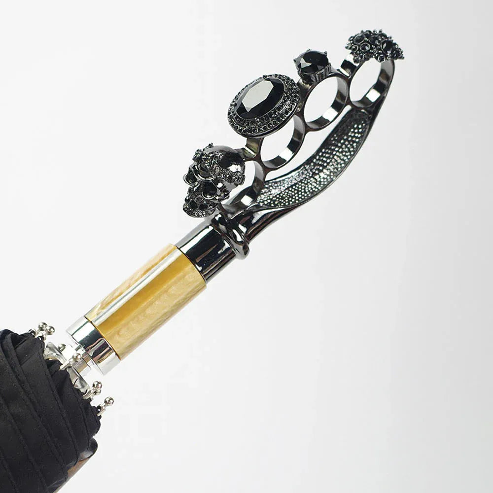 Side view close-up of the ornate gothic ring handle with skull and gem details.