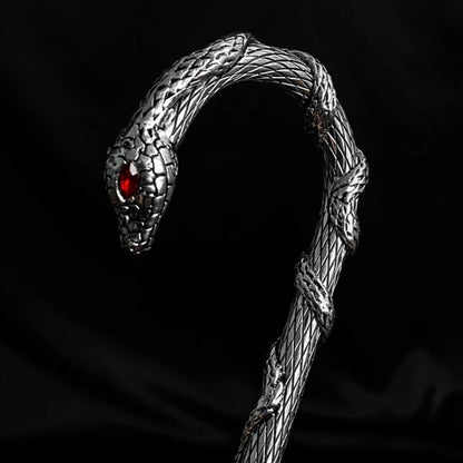 Close-up of the snake handle on the luxury umbrella with striking red eyes.