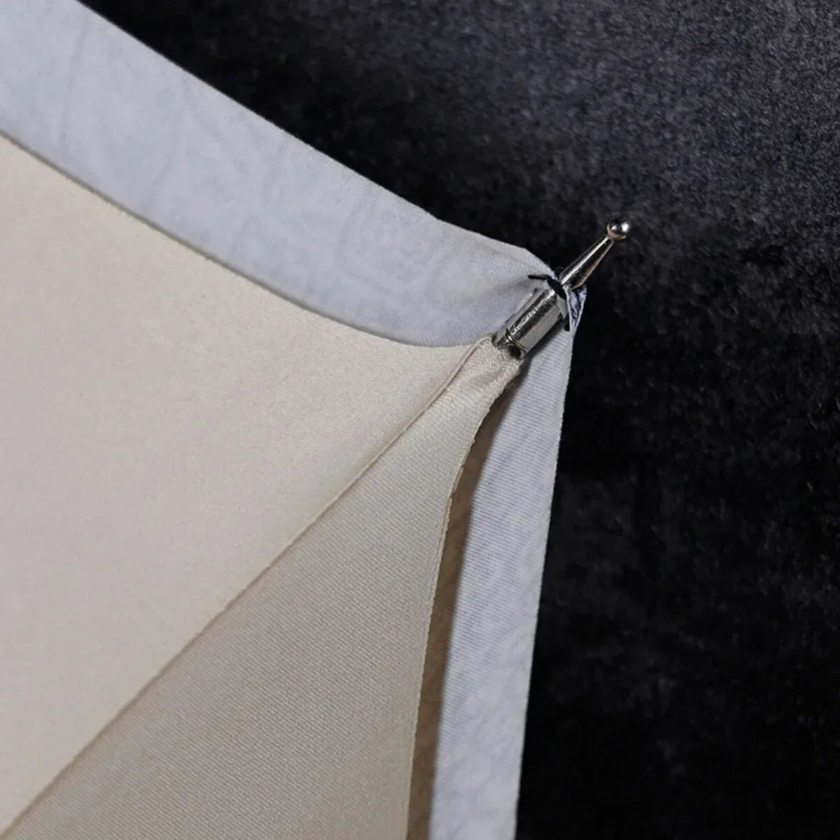 Detail shot from underneath showing the metal tip connection on the edge of the canopy.