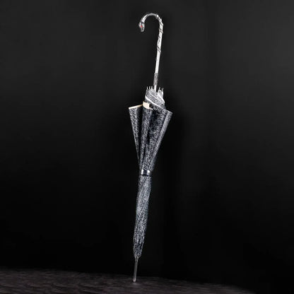 The luxury snake umbrella shown closed, highlighting the serpent pattern canopy and silver snake handle.