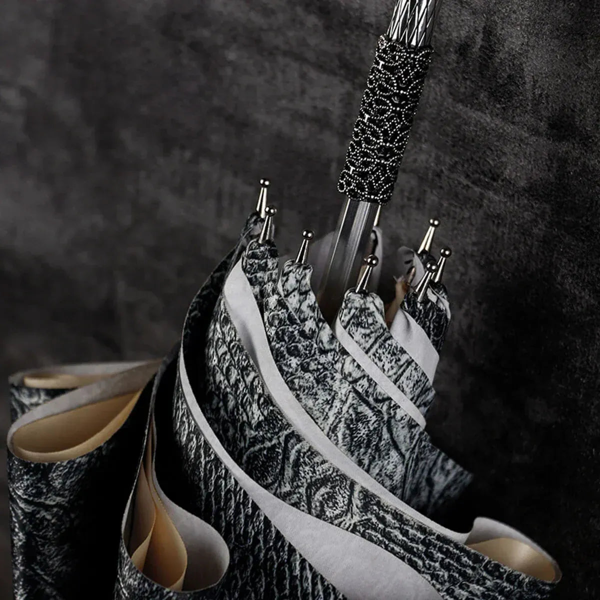 Close-up detail of the textured wrap around the shaft just below the silver snake handle.