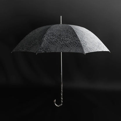 Front view of the open luxury snake umbrella, showcasing the full serpent pattern canopy.