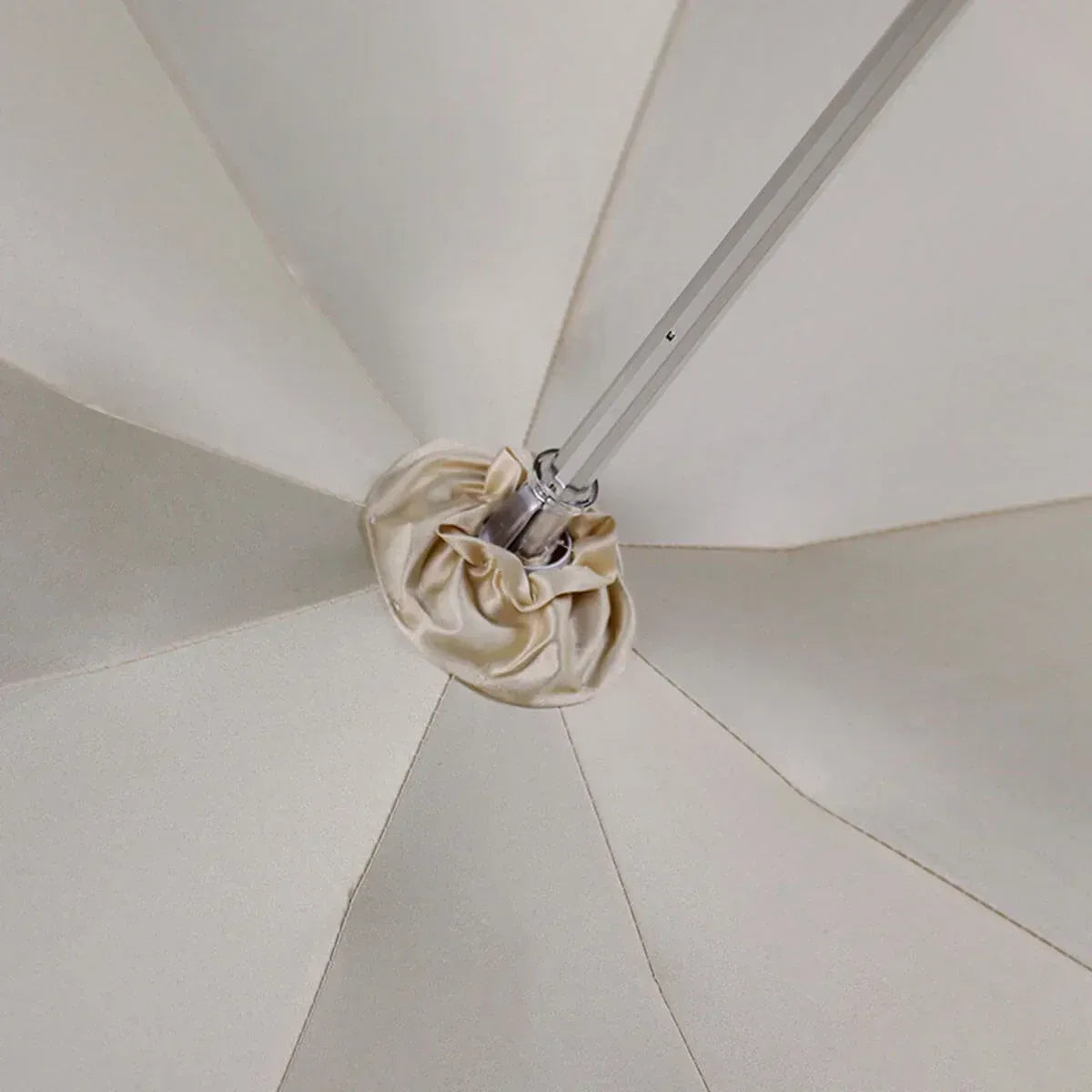 Close-up view from underneath the canopy looking up at the central mechanism and fabric detail.