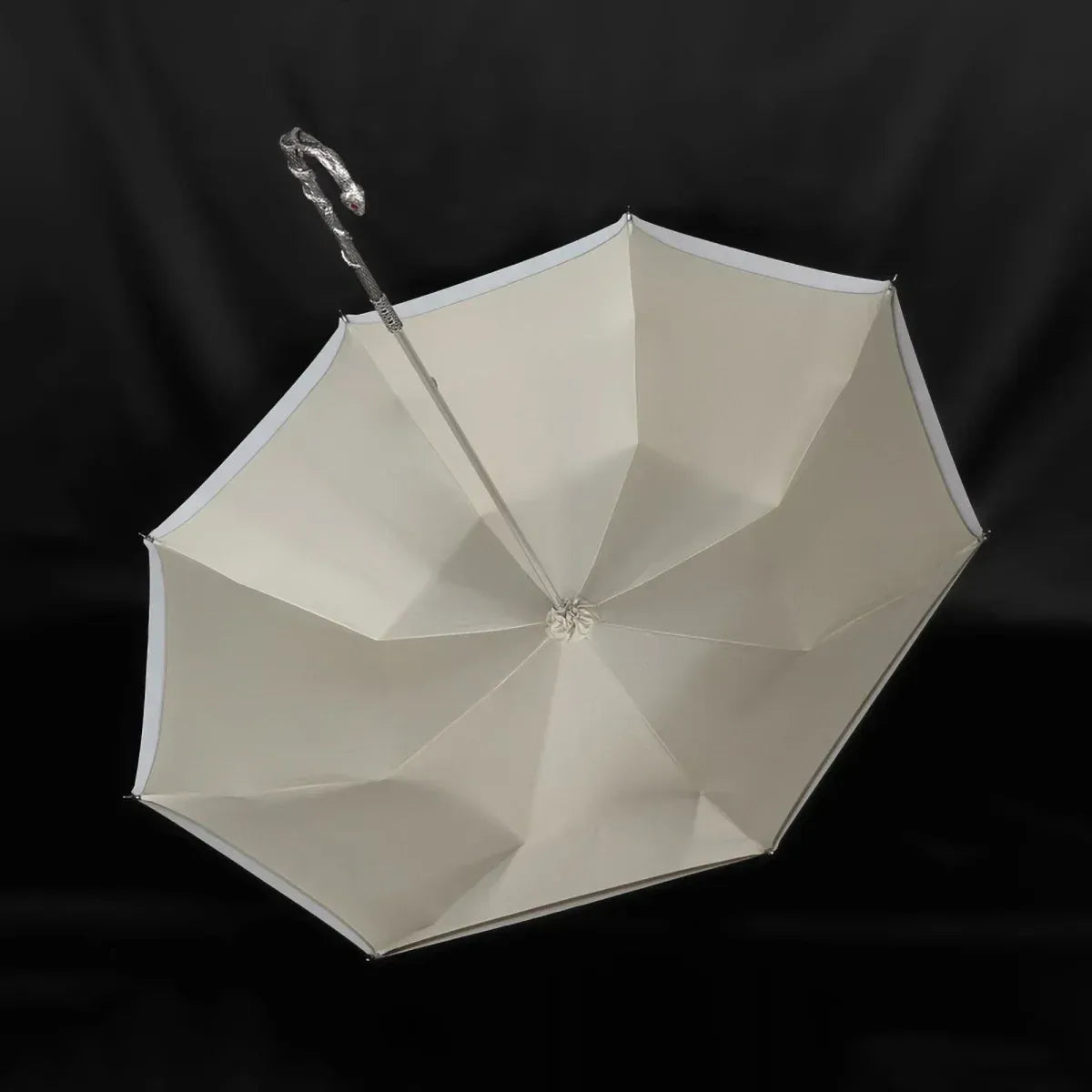 View from underneath the open canopy, showing the cream-colored lining and silver frame.