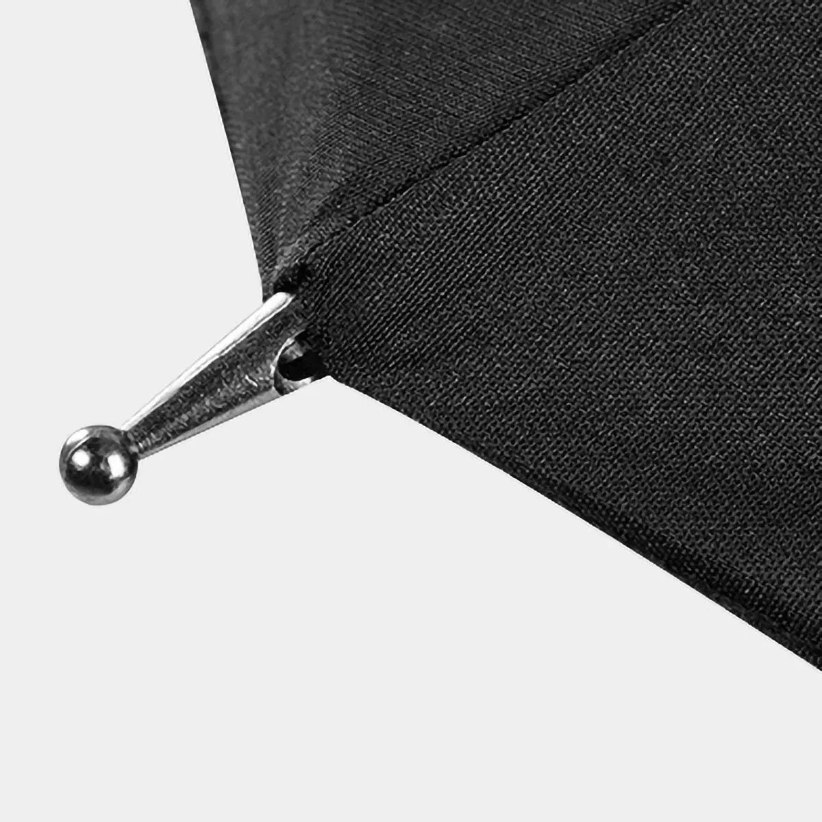 Detail shot of the metal tip on the edge of the black canopy of the walking cane umbrella.