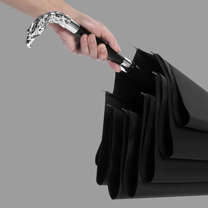 A hand holding the detachable silver Eagle handle, demonstrating the 2-in-1 feature.