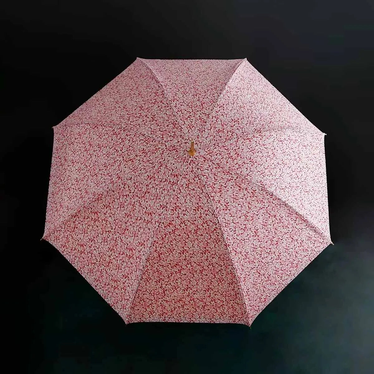Top-down view of the open canopy showing the beautiful pink and white floral pattern.