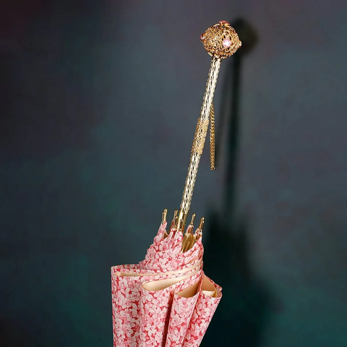 Detailed close-up of the closed pink floral canopy and the luxury jeweled gold handle.
