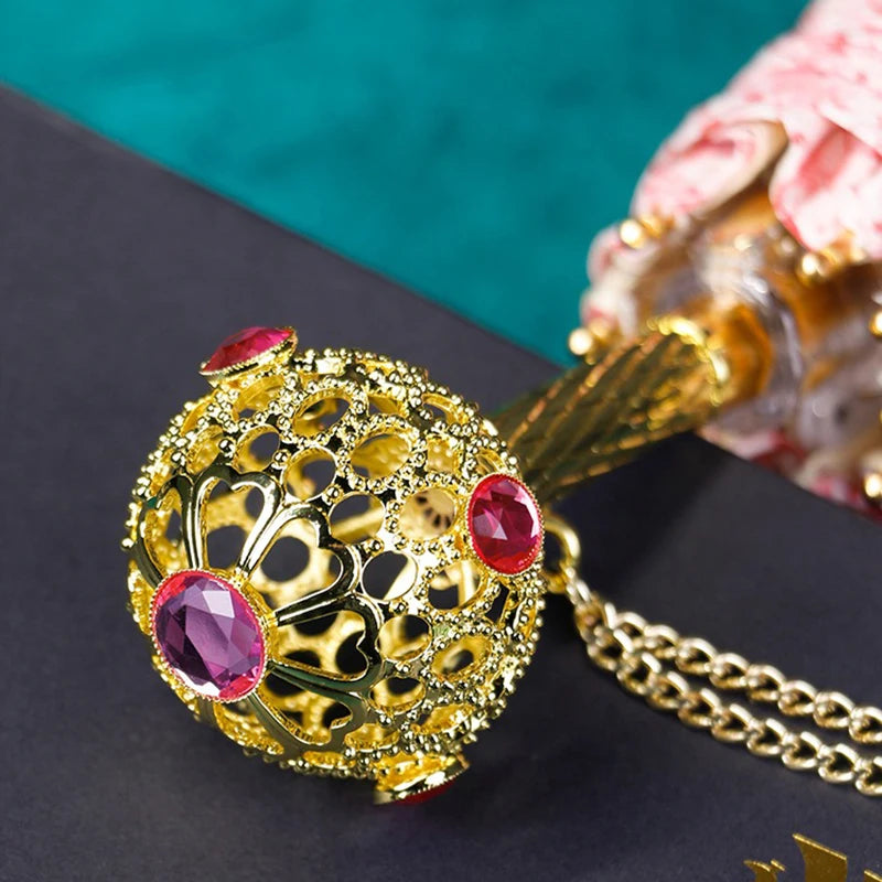 Close-up of the luxury gold handle on the pink floral umbrella.