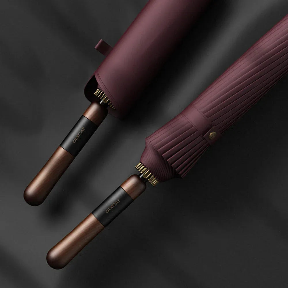 Close-up comparing two burgundy 24-rib umbrella handles, showing wood grain and details.
