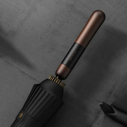 Detailed close-up of the straight wood handle with leather wrap detail and branding.