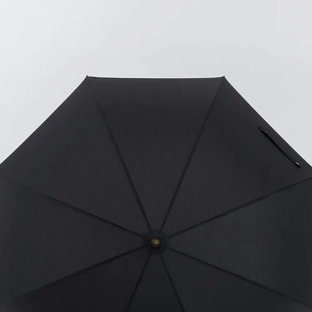 Top-down view of the large 52-inch open black canopy on the premium rain umbrella.