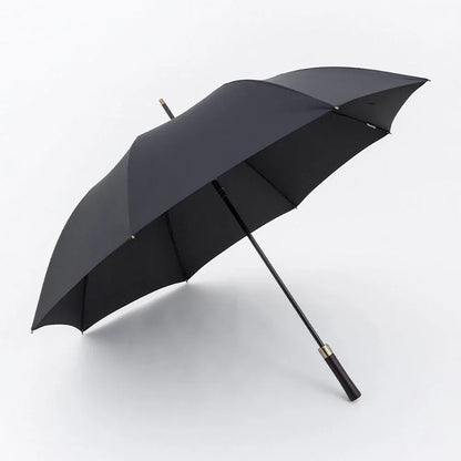 Profile view of the open large 52-inch premium rain umbrella in black with a straight wood handle.
