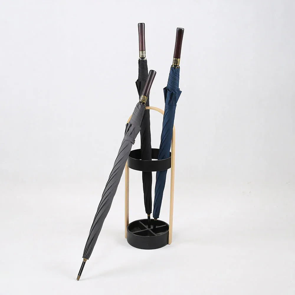 The premium big rain umbrellas in grey, black, and navy shown closed in a modern umbrella stand.