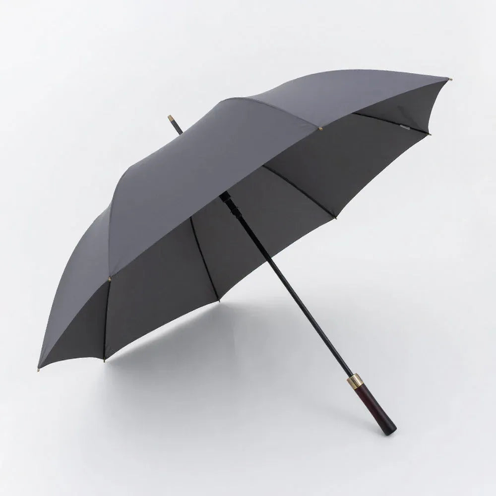 Profile view of the open large 52-inch premium rain umbrella in grey with a straight wood handle.
