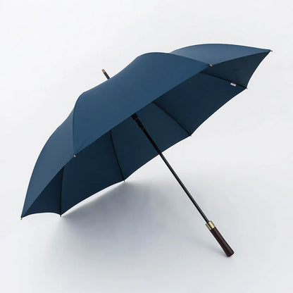 Profile view of the open large 52-inch premium rain umbrella in navy blue with a straight wood handle.