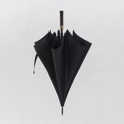 The premium big rain umbrella with a straight wood handle, shown closed in classic black.