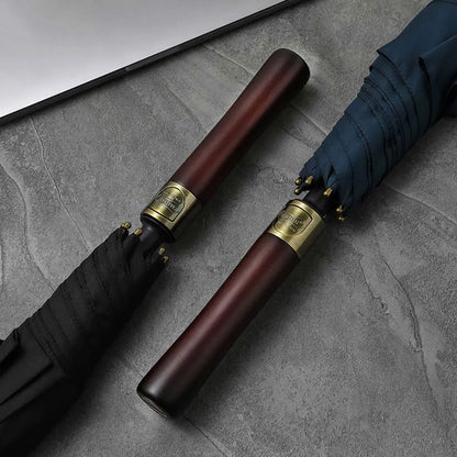 Close-up showing the detail and wood grain of the straight handles on the black and navy umbrellas.