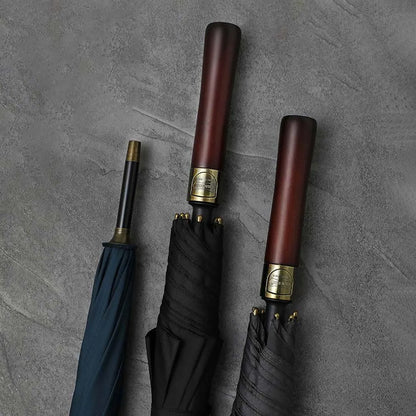 Lifestyle arrangement showing the straight wood handles of the premium umbrellas in black and navy.