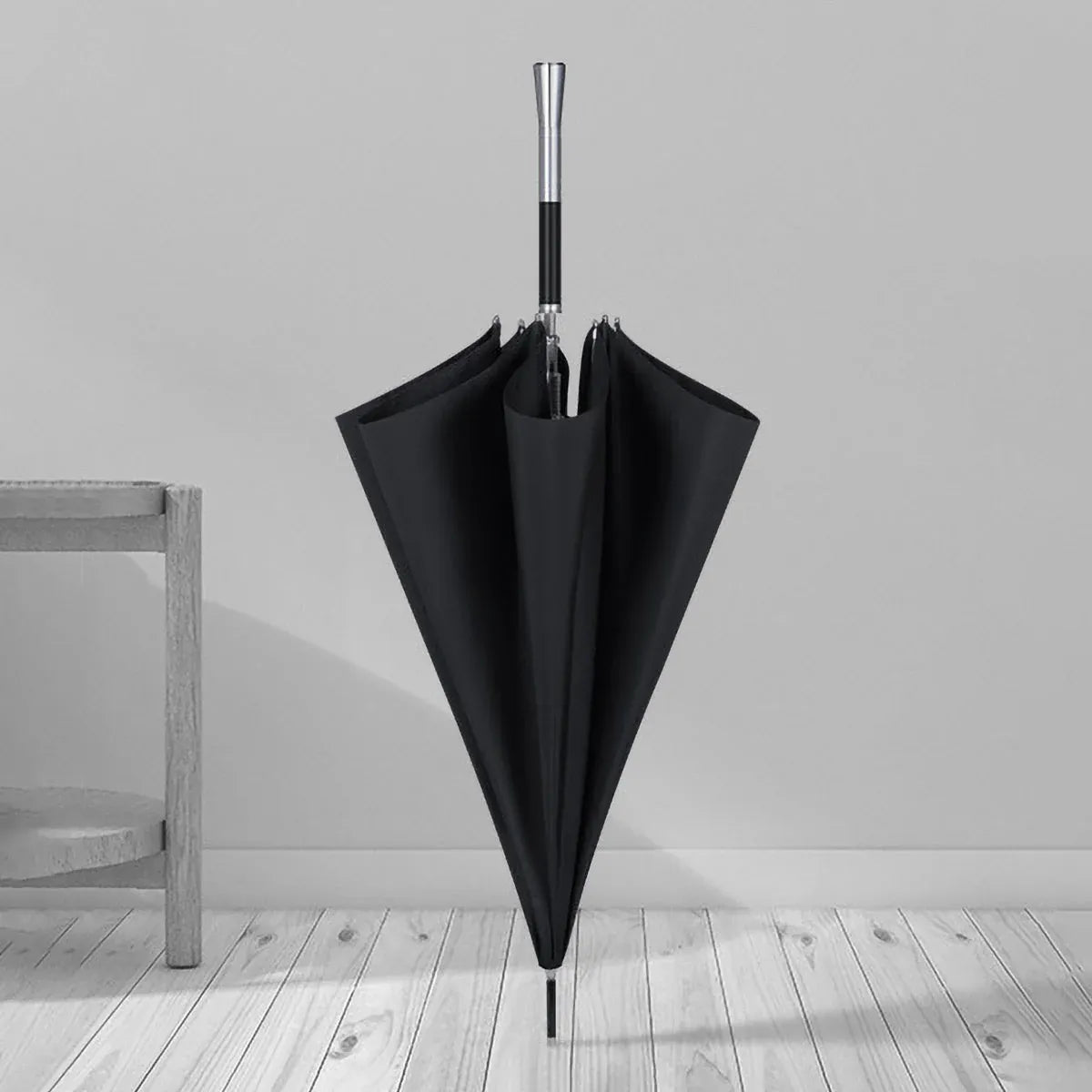 The premium long handle umbrella with alloy handle standing closed in a room setting.