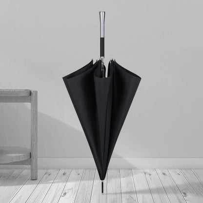 The premium long handle umbrella with alloy handle standing closed in a room setting.