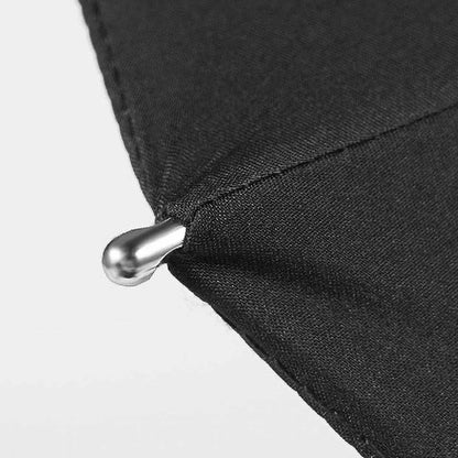 Detail shot of the sturdy metal tip on the edge of the black canopy of the premium long handle umbrella.