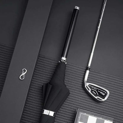 Lifestyle image showing the closed premium long handle umbrella with a dark wooden handle next to a golf club.