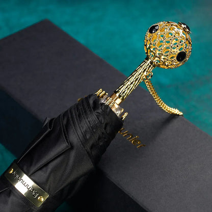 The Prestige crystal handle folding umbrella for women in black, showing the ornate gold handle with black crystals.