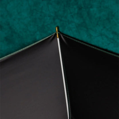 Close-up detail of the canopy tip with gold accent on the Prestige folding umbrella.